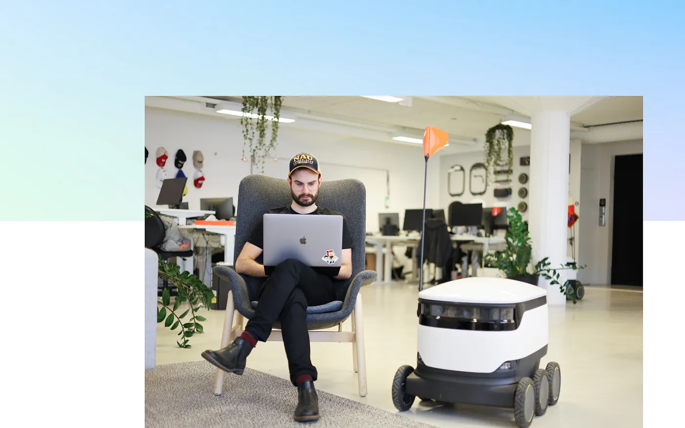 Joakim working on the computer next to a Starship robot