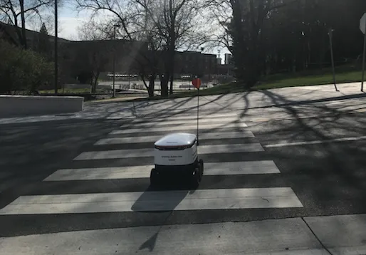 Starship delivery robot crossing a zebra crossing