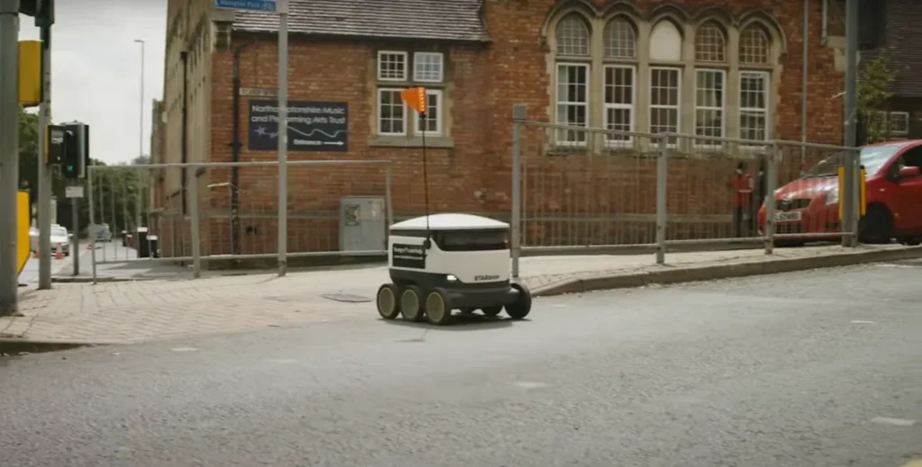 Starship robot crossing at traffic lights