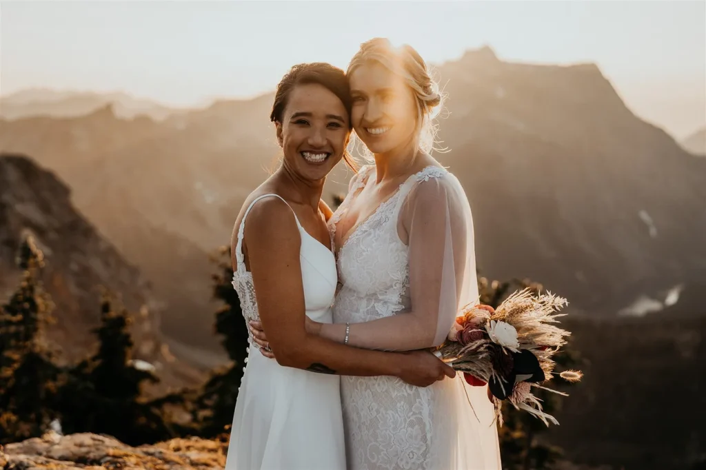 A lesbian couple smiling on her wedding